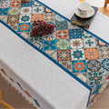 Elegant boho-style tablecloth with colorful geometric patterns and tassels, perfect for adding charm and protecting your dining table.