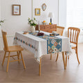 Elegant boho-style tablecloth with colorful geometric patterns and tassels, perfect for adding charm and protecting your dining table.