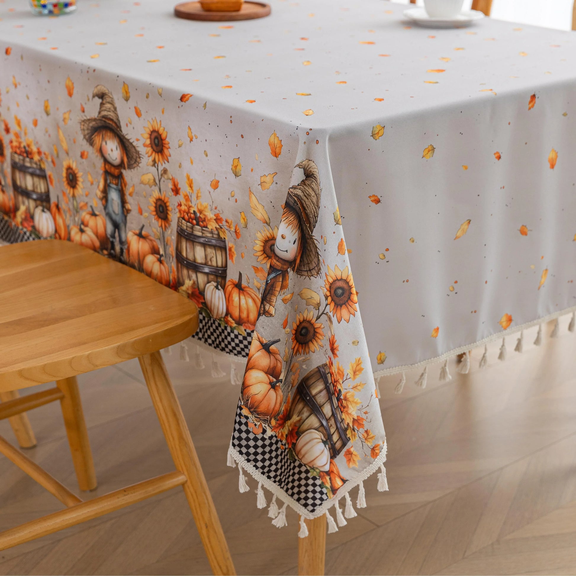 Autumn Harvest Rectangular Tablecloth – Add seasonal charm to your dining space with this festive rectangular tablecloth featuring a delightful harvest design of pumpkins, sunflowers, wooden barrels, and a friendly scarecrow. Accented with a black-and-white checkered border and finished with cream tassels, it brings a cozy farmhouse feel to your table. Perfect for fall gatherings, Thanksgiving dinners, and rustic home décor, this durable and vibrant tablecloth enhances any seasonal celebration.

