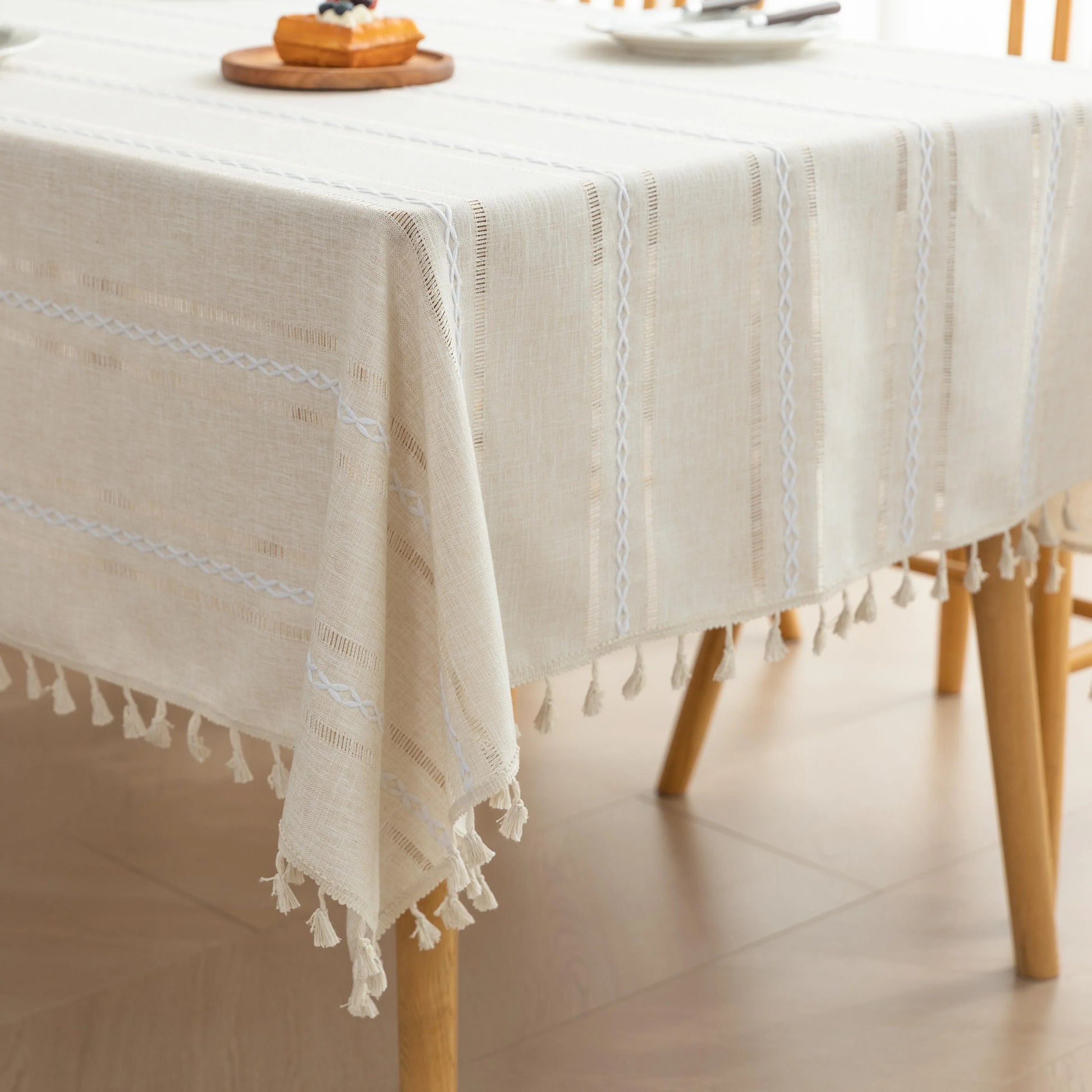 Beige Linen Tassel Tablecloth – Elevate your dining area with this elegant beige tablecloth, crafted from a soft linen-blend fabric for a natural, breathable feel. Featuring subtle white woven stripes and charming tassel edges, it adds a touch of rustic sophistication to both casual meals and festive gatherings. Durable, easy to maintain, and versatile in style, this tablecloth blends seamlessly with farmhouse, bohemian, or modern home décor while protecting your table in timeless fashion.
