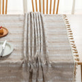 Rustic Linen Tassel Tablecloth – Add a touch of natural elegance to your dining space with this beautiful linen-blend tablecloth, featuring delicate white embroidered stripes and charming tassel edging. Its neutral beige tone effortlessly complements farmhouse, bohemian, and modern interiors, making it perfect for everyday meals or special gatherings. Durable, soft, and easy to clean, this tablecloth not only protects your table but also enhances your dining experience with timeless style and texture.
