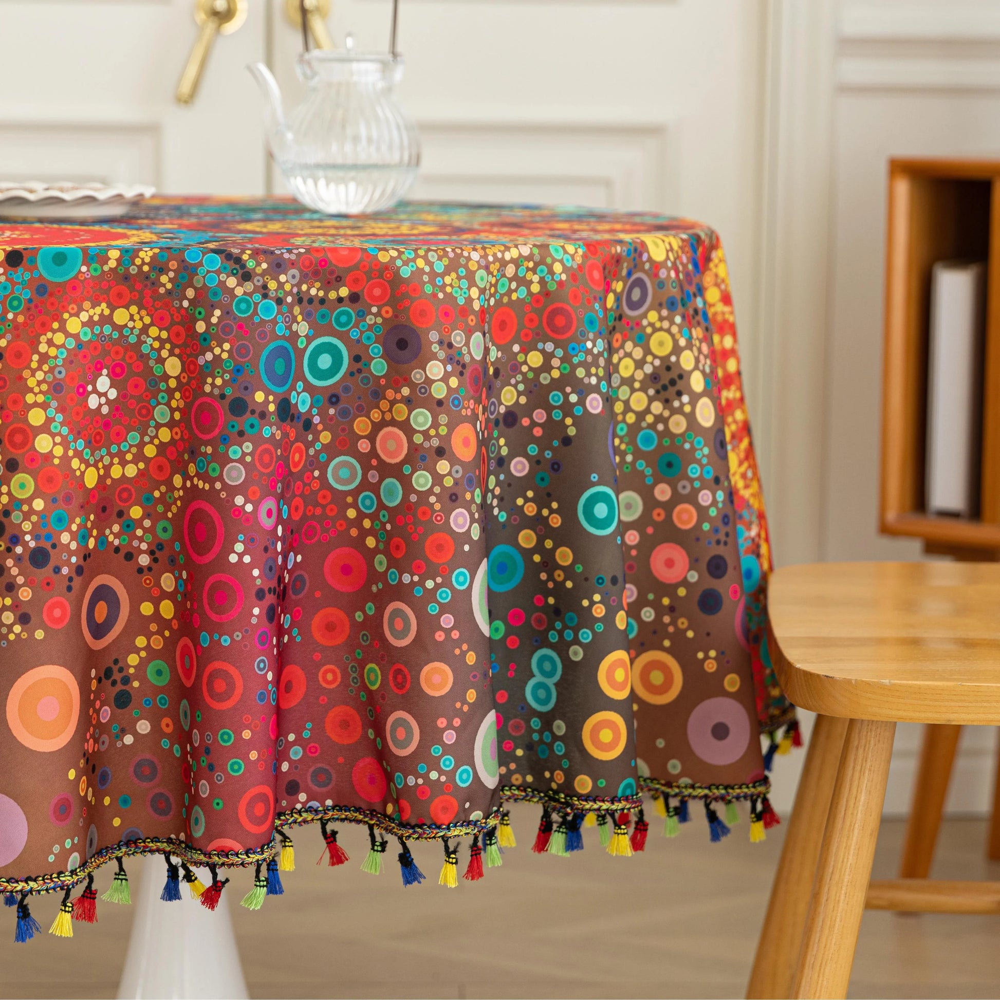 Colorful Bohemian Round Tablecloth – Brighten your dining space with this vibrant round tablecloth featuring an eclectic mix of circular mandala-inspired patterns in bold red, yellow, turquoise, and blue hues. Accented with playful multicolor tassels, it adds a lively and artistic touch to any table setting. Perfect for kitchen tables, garden parties, picnics, or festive gatherings, this durable and eye-catching tablecloth is ideal for both everyday meals and special occasions.
