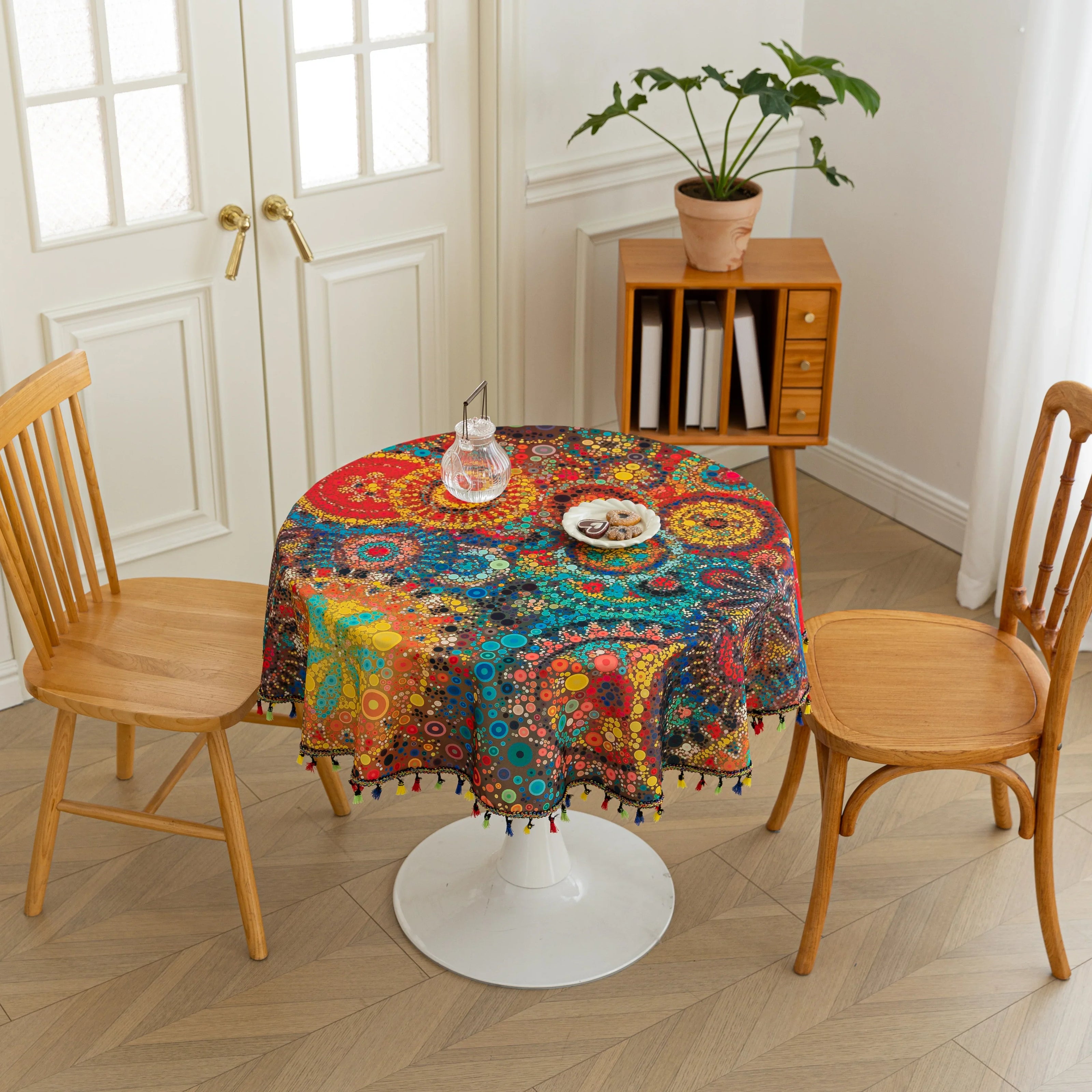 Colorful Bohemian Round Tablecloth ¨C Brighten your dining space with this vibrant round tablecloth featuring an eclectic mix of circular mandala-inspired patterns in bold red, yellow, turquoise, and blue hues. Accented with playful multicolor tassels, it adds a lively and artistic touch to any table setting. Perfect for kitchen tables, garden parties, picnics, or festive gatherings, this durable and eye-catching tablecloth is ideal for both everyday meals and special occasions.
