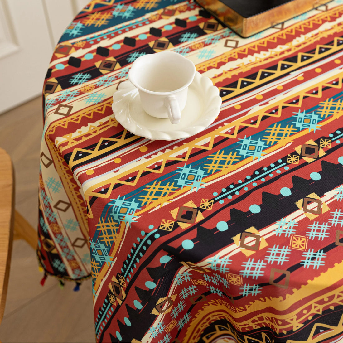 Bohemian Striped Round Tablecloth – Infuse your dining area with vibrant personality using this colorful round tablecloth featuring bold boho-inspired stripes and geometric patterns in rich red, yellow, turquoise, and black tones. Accented with playful multicolor tassels along the edge, it adds a lively and artistic touch to any table setting. Perfect for kitchen tables, coffee nooks, picnics, or festive gatherings, this durable and eye-catching tablecloth is ideal for both everyday use and special occasion