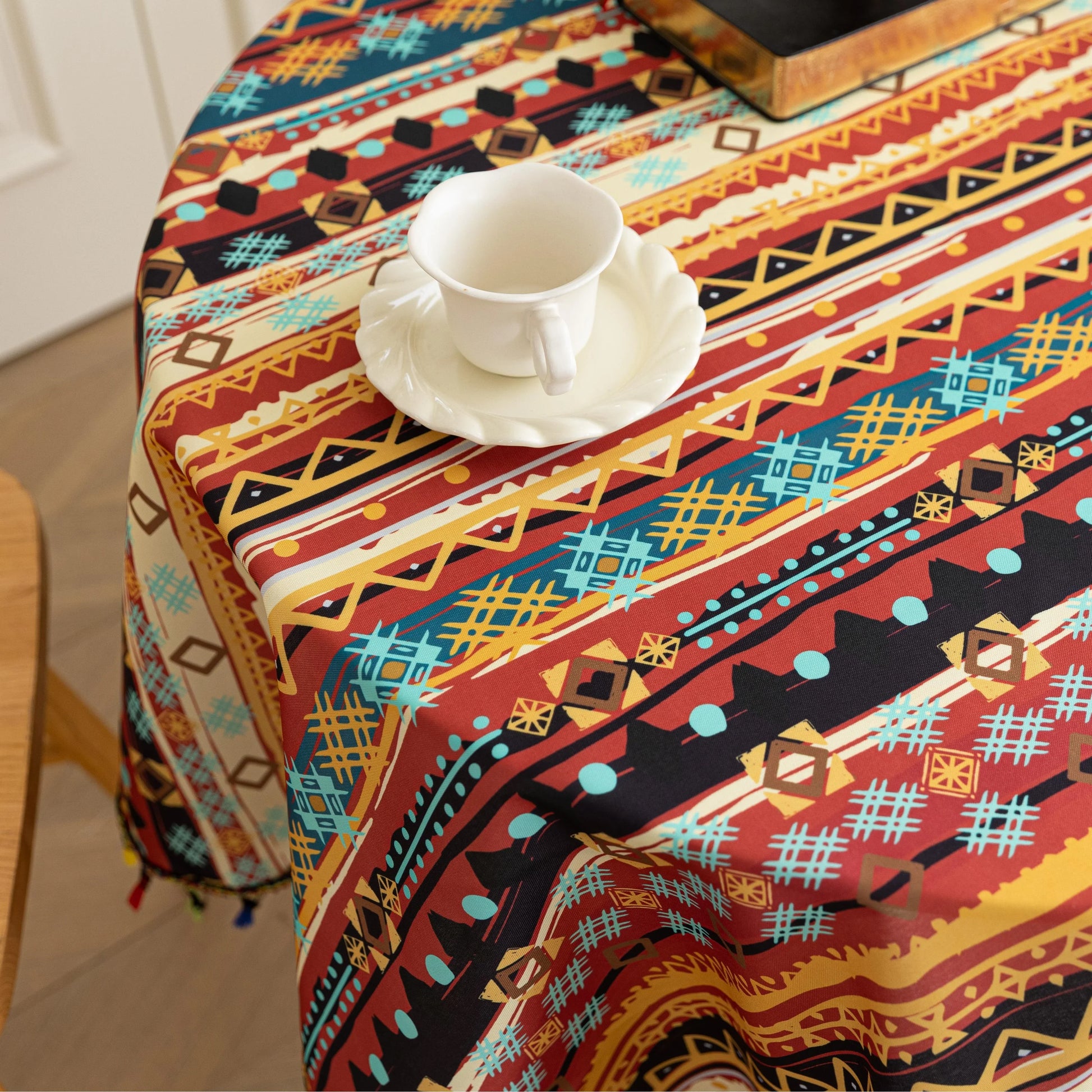 Bohemian Striped Round Tablecloth – Infuse your dining area with vibrant personality using this colorful round tablecloth featuring bold boho-inspired stripes and geometric patterns in rich red, yellow, turquoise, and black tones. Accented with playful multicolor tassels along the edge, it adds a lively and artistic touch to any table setting. Perfect for kitchen tables, coffee nooks, picnics, or festive gatherings, this durable and eye-catching tablecloth is ideal for both everyday use and special occasion
