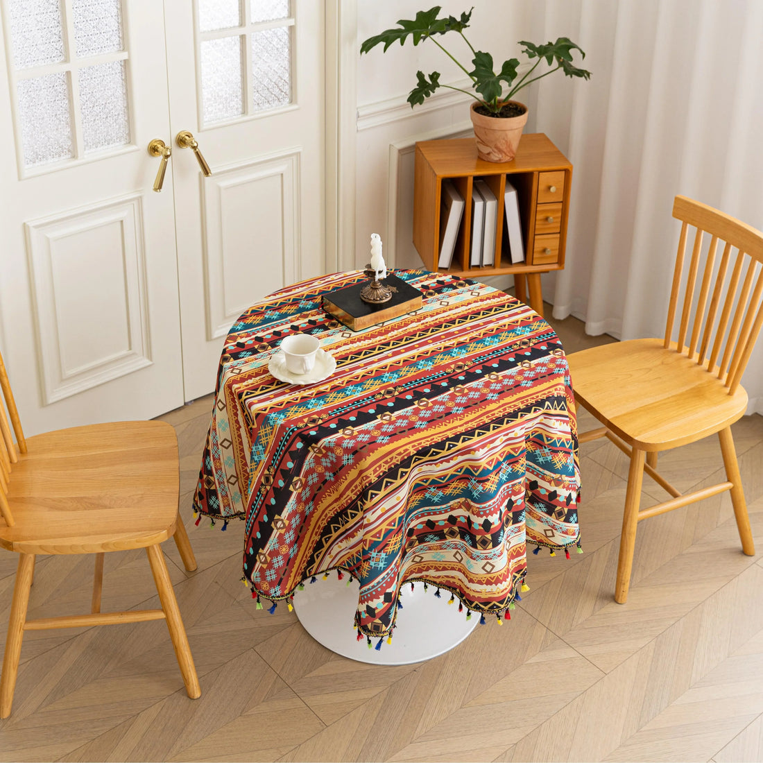 Bohemian Striped Round Tablecloth – Infuse your dining area with vibrant personality using this colorful round tablecloth featuring bold boho-inspired stripes and geometric patterns in rich red, yellow, turquoise, and black tones. Accented with playful multicolor tassels along the edge, it adds a lively and artistic touch to any table setting. Perfect for kitchen tables, coffee nooks, picnics, or festive gatherings, this durable and eye-catching tablecloth is ideal for both everyday use and special occasion