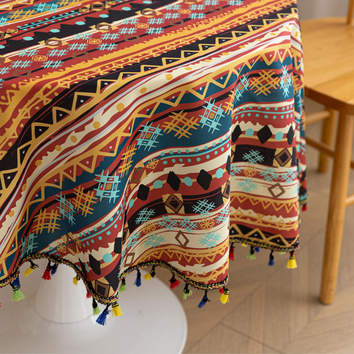 Bohemian Striped Round Tablecloth ¨C Infuse your dining area with vibrant personality using this colorful round tablecloth featuring bold boho-inspired stripes and geometric patterns in rich red, yellow, turquoise, and black tones. Accented with playful multicolor tassels along the edge, it adds a lively and artistic touch to any table setting. Perfect for kitchen tables, coffee nooks, picnics, or festive gatherings, this durable and eye-catching tablecloth is ideal for both everyday use and special occasio