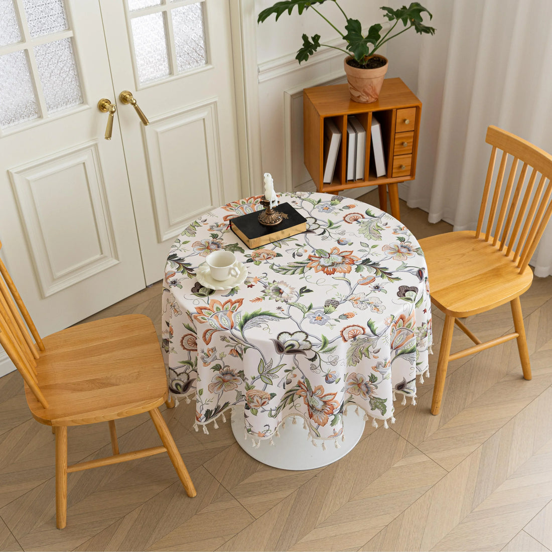 Vintage Floral Round Tablecloth – Brighten your dining space with this elegant round tablecloth featuring a soft cream background adorned with intricate multicolor floral patterns. Detailed with graceful vines and blooms in warm earthy tones, it’s finished with delicate white tassels for a charming touch. Perfect for kitchen tables, coffee corners, or garden parties, this durable and stylish tablecloth complements farmhouse, cottage, and classic décor styles.
