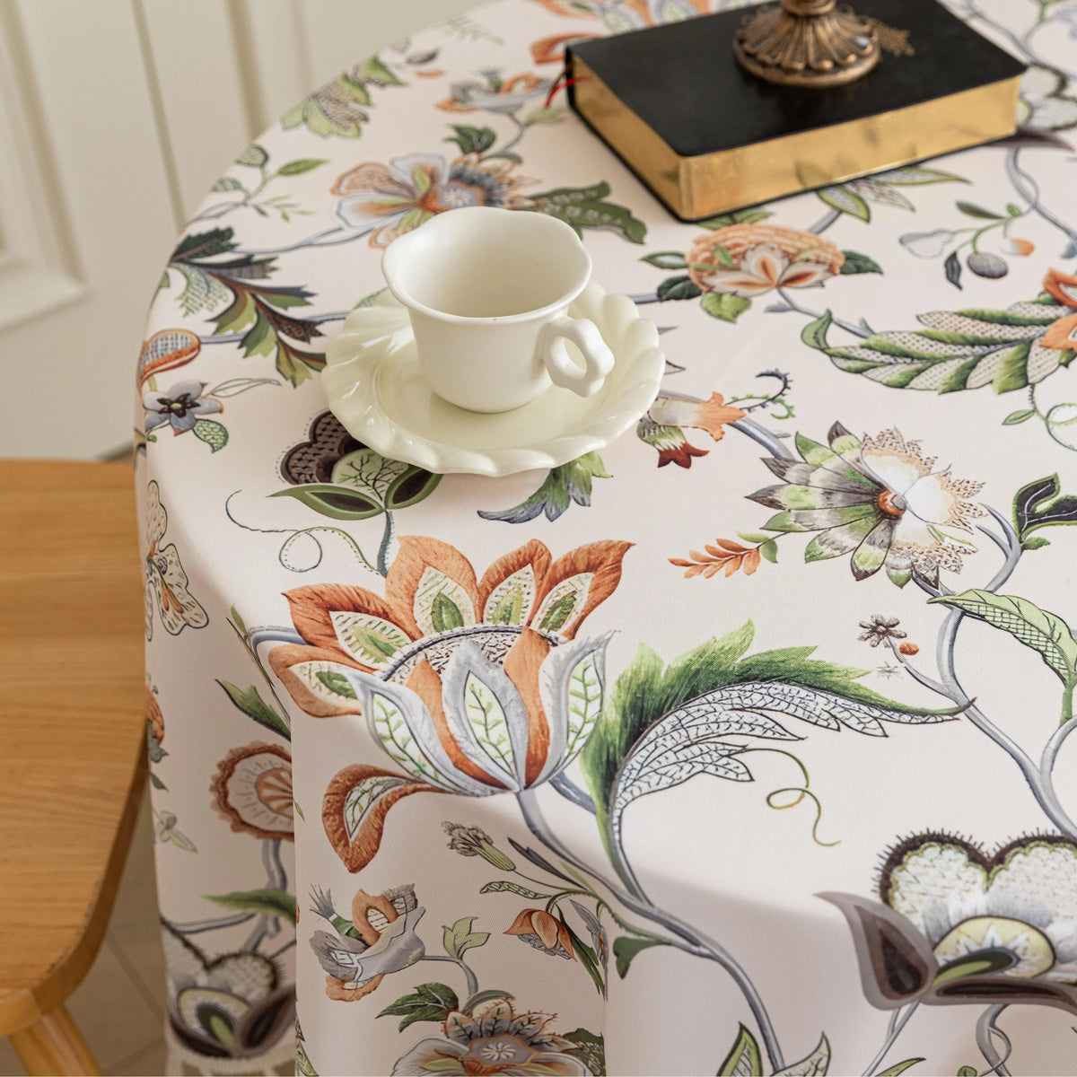 Vintage Floral Round Tablecloth ¨C Brighten your dining space with this elegant round tablecloth featuring a soft cream background adorned with intricate multicolor floral patterns. Detailed with graceful vines and blooms in warm earthy tones, it¡¯s finished with delicate white tassels for a charming touch. Perfect for kitchen tables, coffee corners, or garden parties, this durable and stylish tablecloth complements farmhouse, cottage, and classic d¨¦cor styles.
