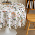 Vintage Floral Round Tablecloth – Brighten your dining space with this elegant round tablecloth featuring a soft cream background adorned with intricate multicolor floral patterns. Detailed with graceful vines and blooms in warm earthy tones, it’s finished with delicate white tassels for a charming touch. Perfect for kitchen tables, coffee corners, or garden parties, this durable and stylish tablecloth complements farmhouse, cottage, and classic décor styles.
