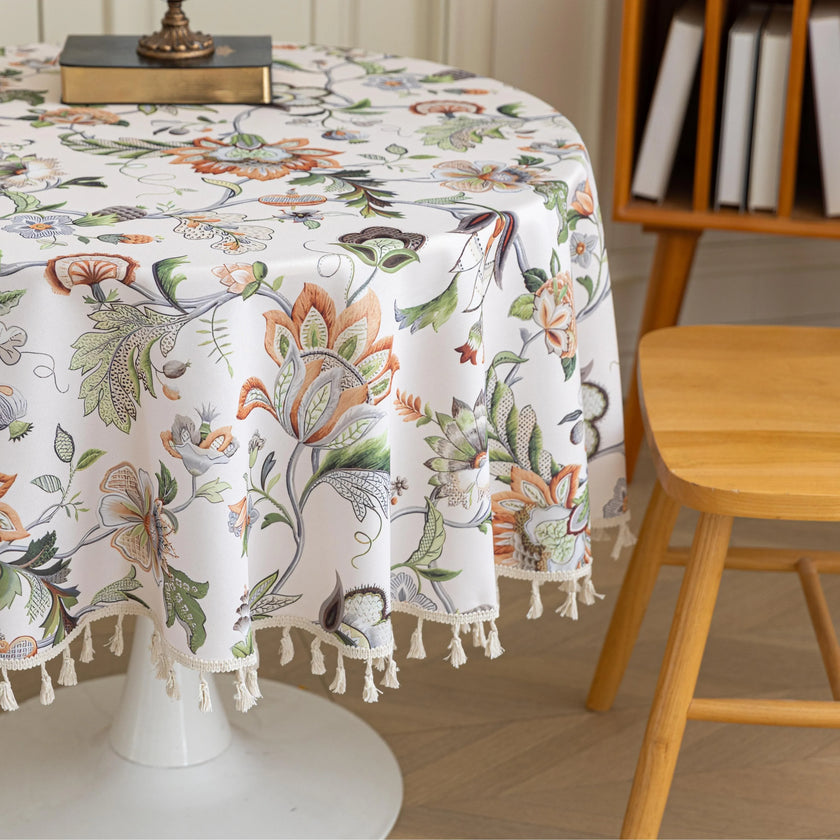 Vintage Floral Round Tablecloth ¨C Brighten your dining space with this elegant round tablecloth featuring a soft cream background adorned with intricate multicolor floral patterns. Detailed with graceful vines and blooms in warm earthy tones, it¡¯s finished with delicate white tassels for a charming touch. Perfect for kitchen tables, coffee corners, or garden parties, this durable and stylish tablecloth complements farmhouse, cottage, and classic d¨¦cor styles.
