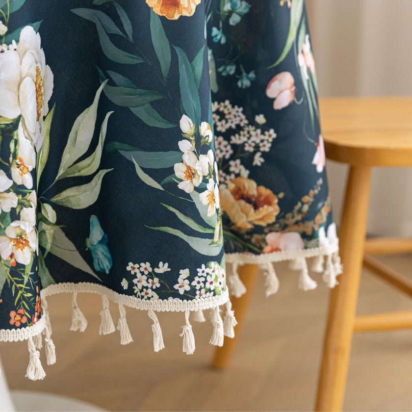 Elegant Dark Floral Round Tablecloth ¨C Add a touch of sophistication to your dining area with this round tablecloth featuring a rich dark green background adorned with vibrant floral prints in shades of orange, pink, and white. Finished with delicate white tassels, it combines elegance with charm, making it perfect for everyday meals, tea parties, or special gatherings. Durable and stylish, it complements both modern and classic home d¨¦cor.
