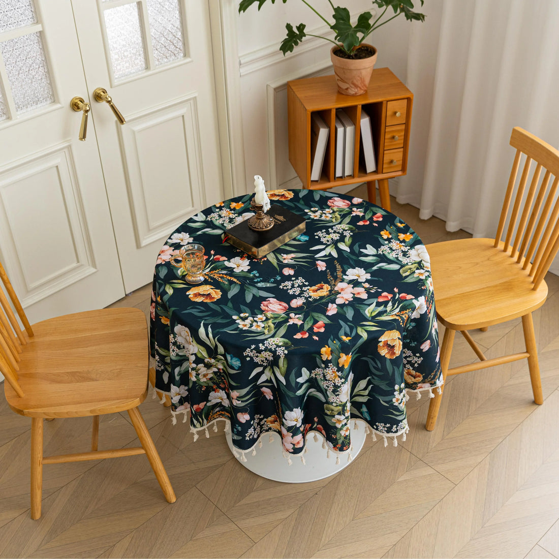 Elegant Dark Floral Round Tablecloth – Add a touch of sophistication to your dining area with this round tablecloth featuring a rich dark green background adorned with vibrant floral prints in shades of orange, pink, and white. Finished with delicate white tassels, it combines elegance with charm, making it perfect for everyday meals, tea parties, or special gatherings. Durable and stylish, it complements both modern and classic home décor.
