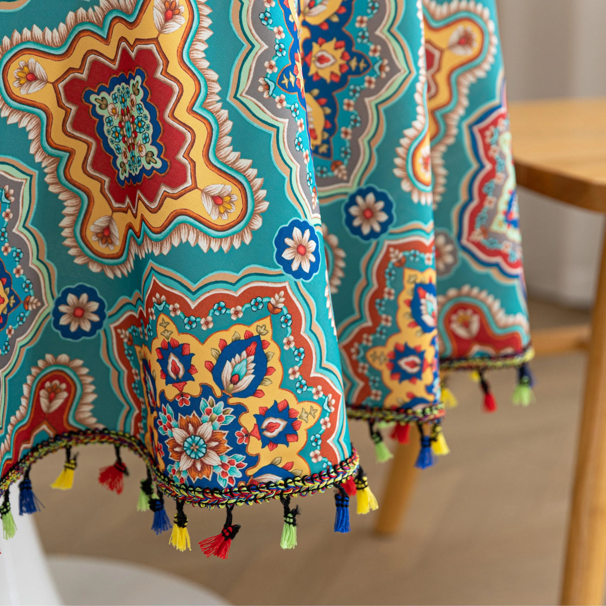 Bohemian Round Tablecloth ¨C Add vibrant charm to your dining area with this colorful round tablecloth featuring intricate Moroccan-inspired patterns in bold turquoise, red, and yellow hues. Finished with playful multicolor tassels along the edge, it brings a lively boho flair to both indoor and outdoor dining. Perfect for kitchen tables, coffee nooks, or garden parties, this durable and eye-catching tablecloth is ideal for everyday use or special occasions.

