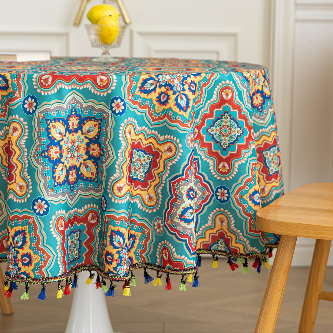Bohemian Round Tablecloth – Add vibrant charm to your dining area with this colorful round tablecloth featuring intricate Moroccan-inspired patterns in bold turquoise, red, and yellow hues. Finished with playful multicolor tassels along the edge, it brings a lively boho flair to both indoor and outdoor dining. Perfect for kitchen tables, coffee nooks, or garden parties, this durable and eye-catching tablecloth is ideal for everyday use or special occasions.
