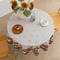 Autumn Harvest Round Tablecloth – Celebrate the cozy season with this charming round tablecloth featuring a delightful harvest design of pumpkins, sunflowers, barrels, and scarecrows. Accented with a black-and-white checkered border and finished with cream tassels, it brings a warm, festive touch to your dining space. Perfect for fall gatherings, Thanksgiving dinners, or seasonal décor, this durable and vibrant tablecloth adds rustic charm to any table setting.
