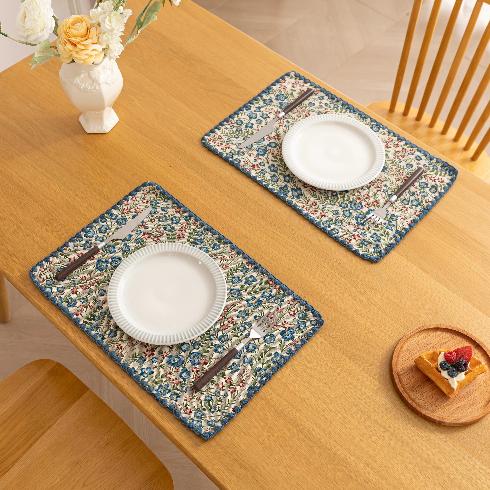 Charming floral woven placemat with blue and red blooms, perfect for adding a fresh, cottage-style touch to your dining table.