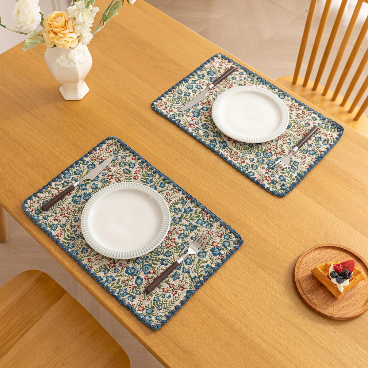 Charming floral woven placemat with blue and red blooms, perfect for adding a fresh, cottage-style touch to your dining table.