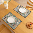 Charming floral woven placemat with blue and red blooms, perfect for adding a fresh, cottage-style touch to your dining table.