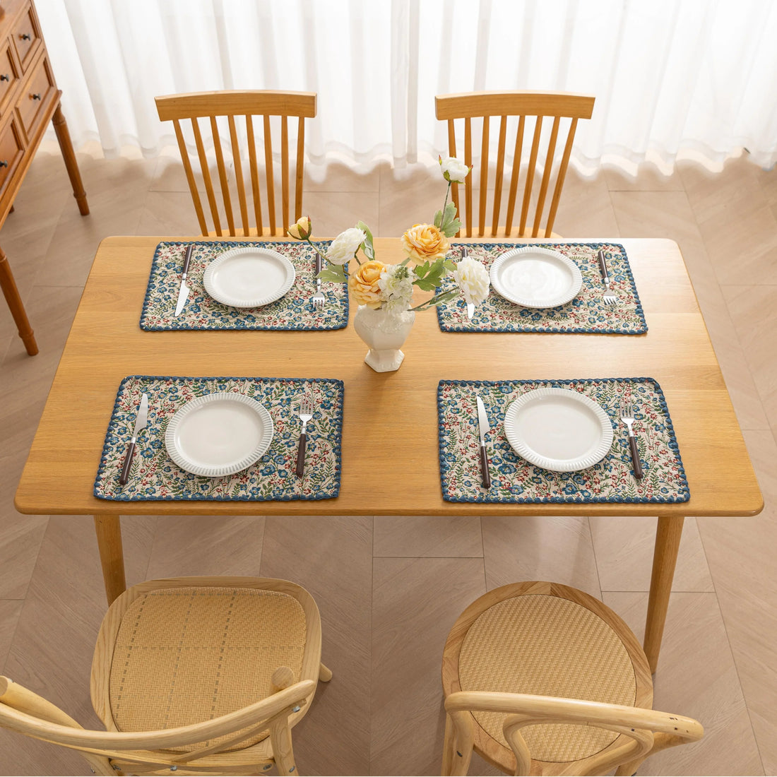 Charming floral woven placemat with blue and red blooms, perfect for adding a fresh, cottage-style touch to your dining table.