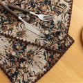 Elegant floral woven placemat in earthy tones, perfect for adding a classic, rustic charm to your dining table while offering durable protection.
