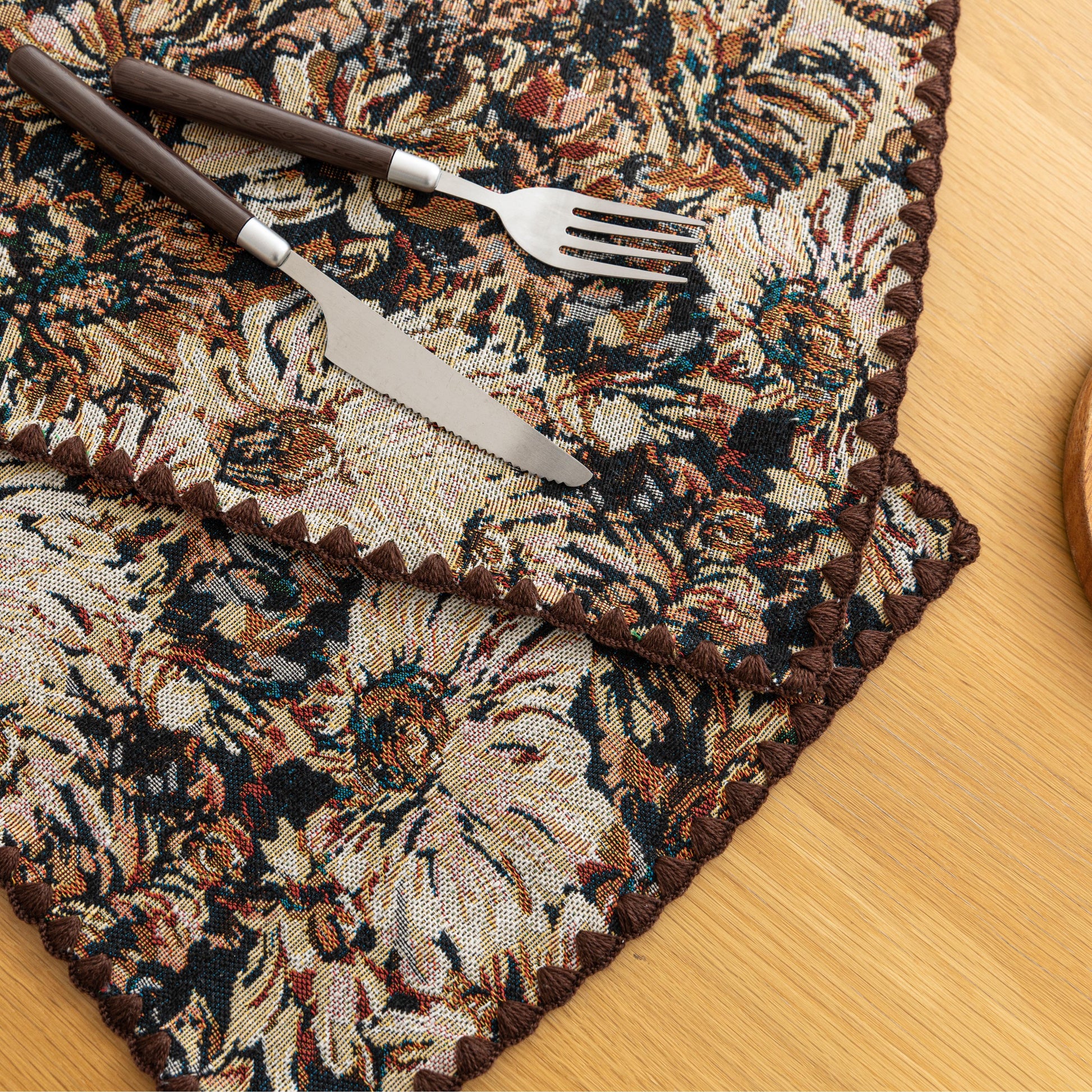 Elegant floral woven placemat in earthy tones, perfect for adding a classic, rustic charm to your dining table while offering durable protection.