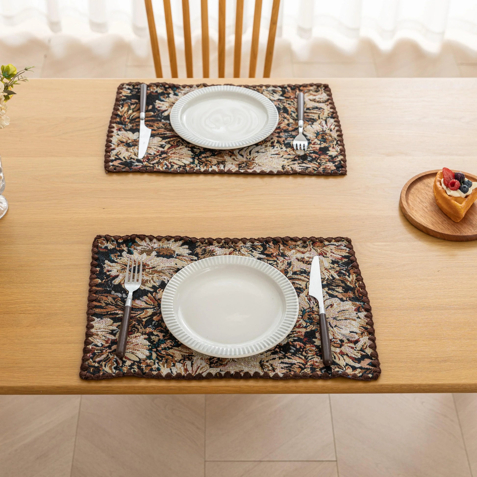 Elegant floral woven placemat in earthy tones, perfect for adding a classic, rustic charm to your dining table while offering durable protection.