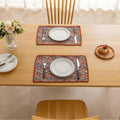 Colorful woven placemat with intricate diamond patterns, adding a vibrant boho touch while protecting your dining table.