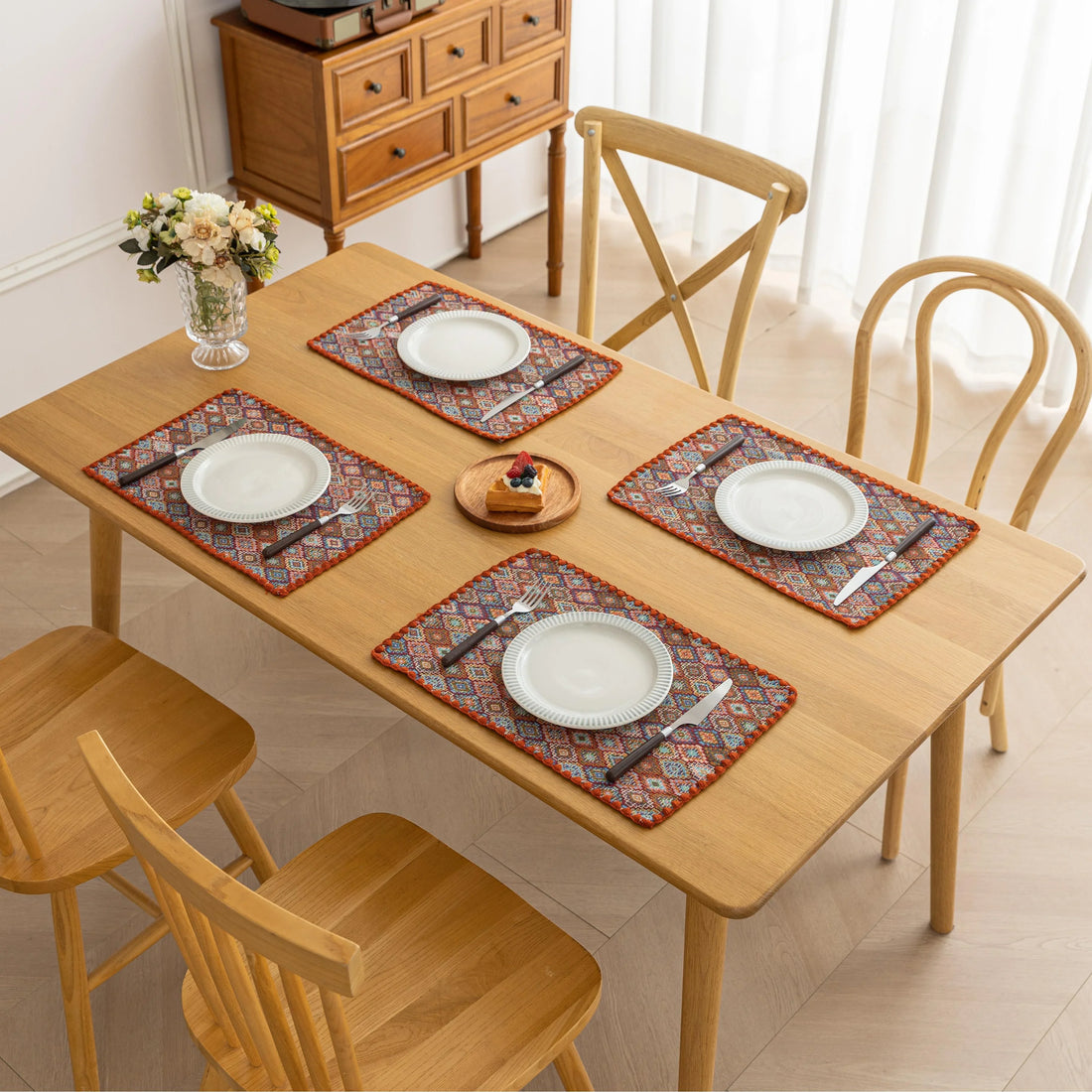 Colorful woven placemat with intricate diamond patterns, adding a vibrant boho touch while protecting your dining table.