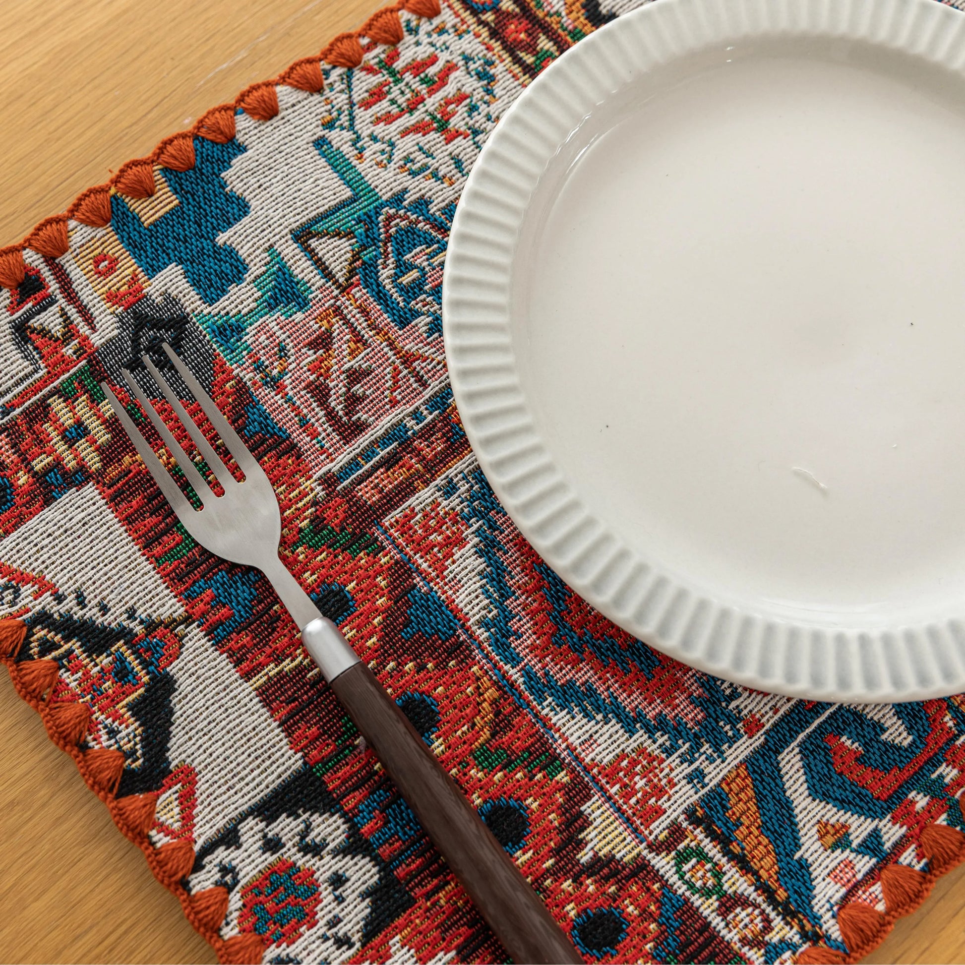 Bohemian woven placemat with vibrant geometric patterns, perfect for adding rustic charm and protecting your table during meals.