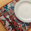 Bohemian woven placemat with vibrant geometric patterns, perfect for adding rustic charm and protecting your table during meals.