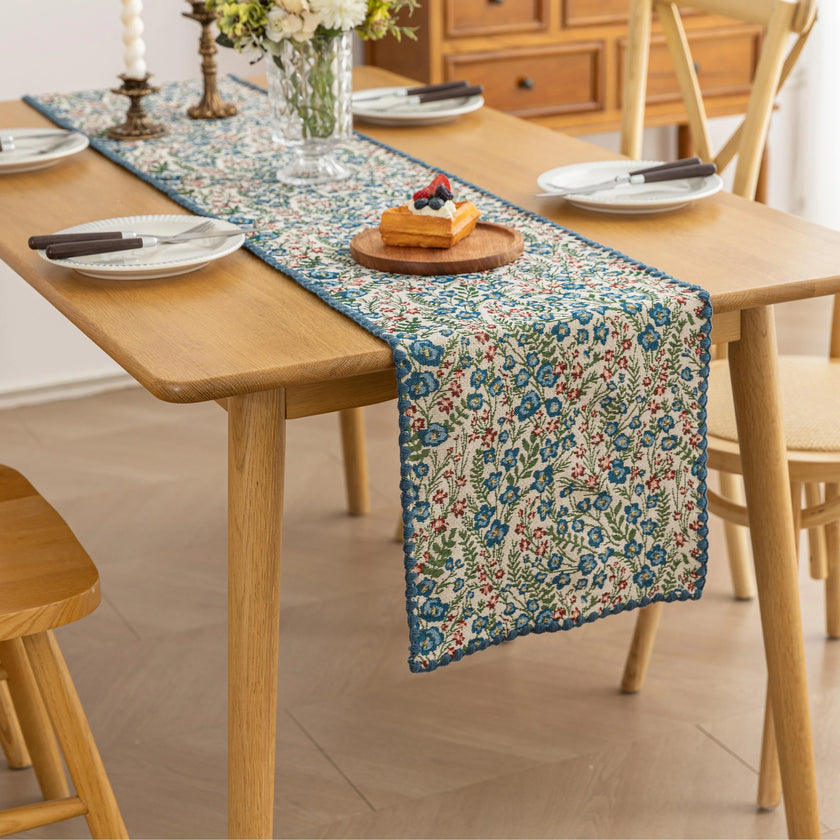 Vintage Floral Table Runner ¨C Bring a touch of timeless charm to your dining space with this beautifully woven table runner featuring delicate blue and red floral patterns on a soft cream background. Accented with a subtle blue border, it adds a fresh and inviting feel to any table setting. Perfect for everyday meals, afternoon tea, or special occasions, this durable and stylish runner complements farmhouse, cottage, and classic home d¨¦cor styles.
