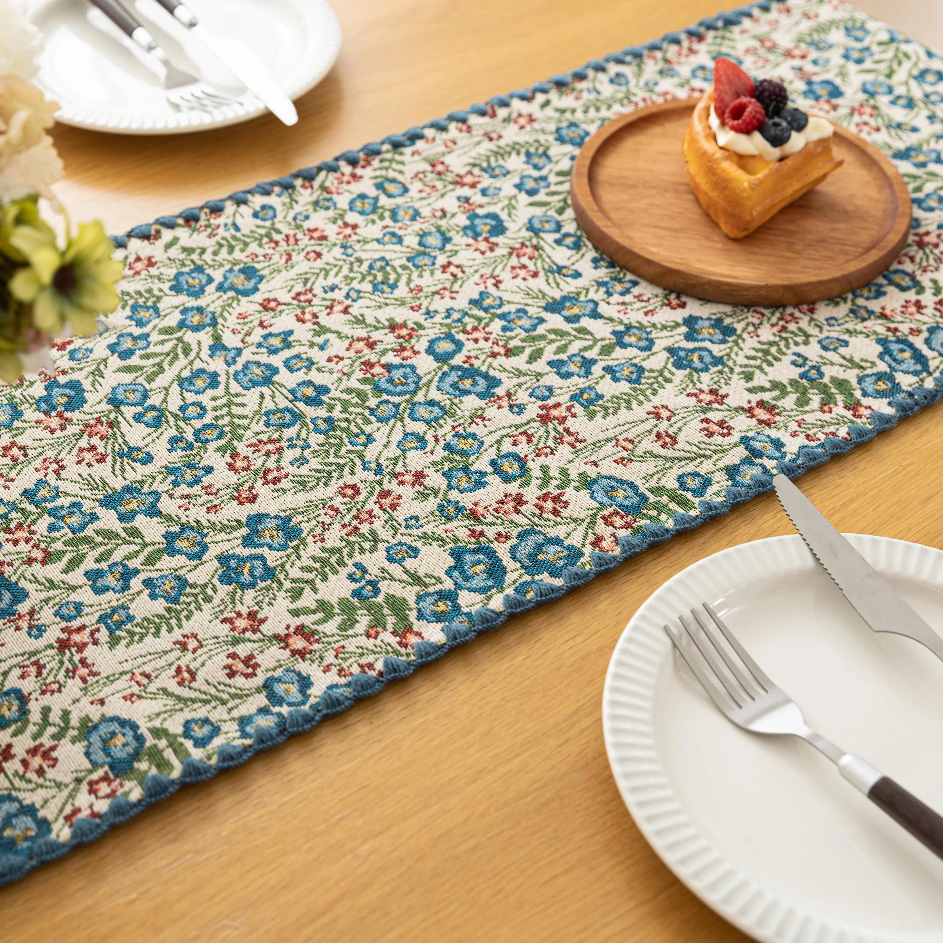 Vintage Floral Table Runner ¨C Bring a touch of timeless charm to your dining space with this beautifully woven table runner featuring delicate blue and red floral patterns on a soft cream background. Accented with a subtle blue border, it adds a fresh and inviting feel to any table setting. Perfect for everyday meals, afternoon tea, or special occasions, this durable and stylish runner complements farmhouse, cottage, and classic home d¨¦cor styles.

