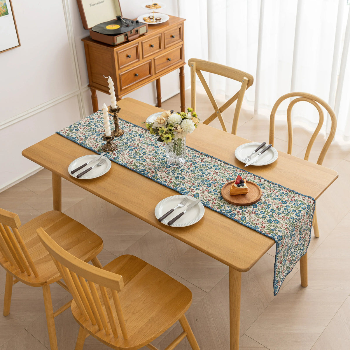 Vintage Floral Table Runner ¨C Bring a touch of timeless charm to your dining space with this beautifully woven table runner featuring delicate blue and red floral patterns on a soft cream background. Accented with a subtle blue border, it adds a fresh and inviting feel to any table setting. Perfect for everyday meals, afternoon tea, or special occasions, this durable and stylish runner complements farmhouse, cottage, and classic home d¨¦cor styles.
