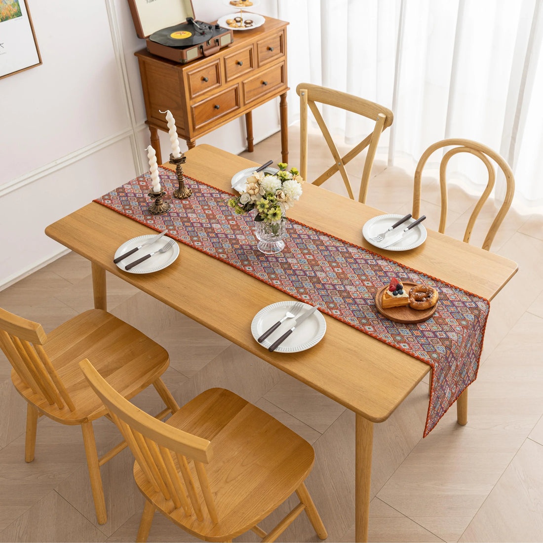 Bohemian Geometric Table Runner – Brighten up your dining space with this colorful, intricately woven table runner featuring a detailed geometric diamond pattern. Designed in rich, earthy tones with a warm orange border, it brings a stylish boho-chic touch to your dining table, coffee table, or sideboard. Perfect for everyday use or special occasions, this durable and decorative runner adds both texture and personality to your home décor.
