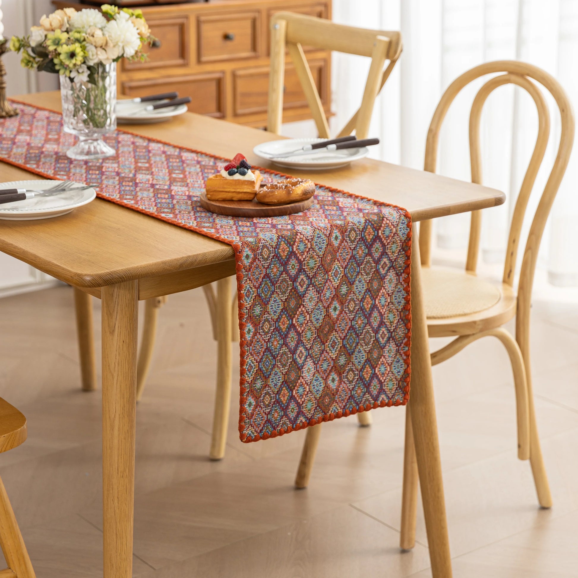 Colorful woven table runner with intricate diamond patterns, perfect for adding a vibrant boho touch to your dining or coffee table décor.