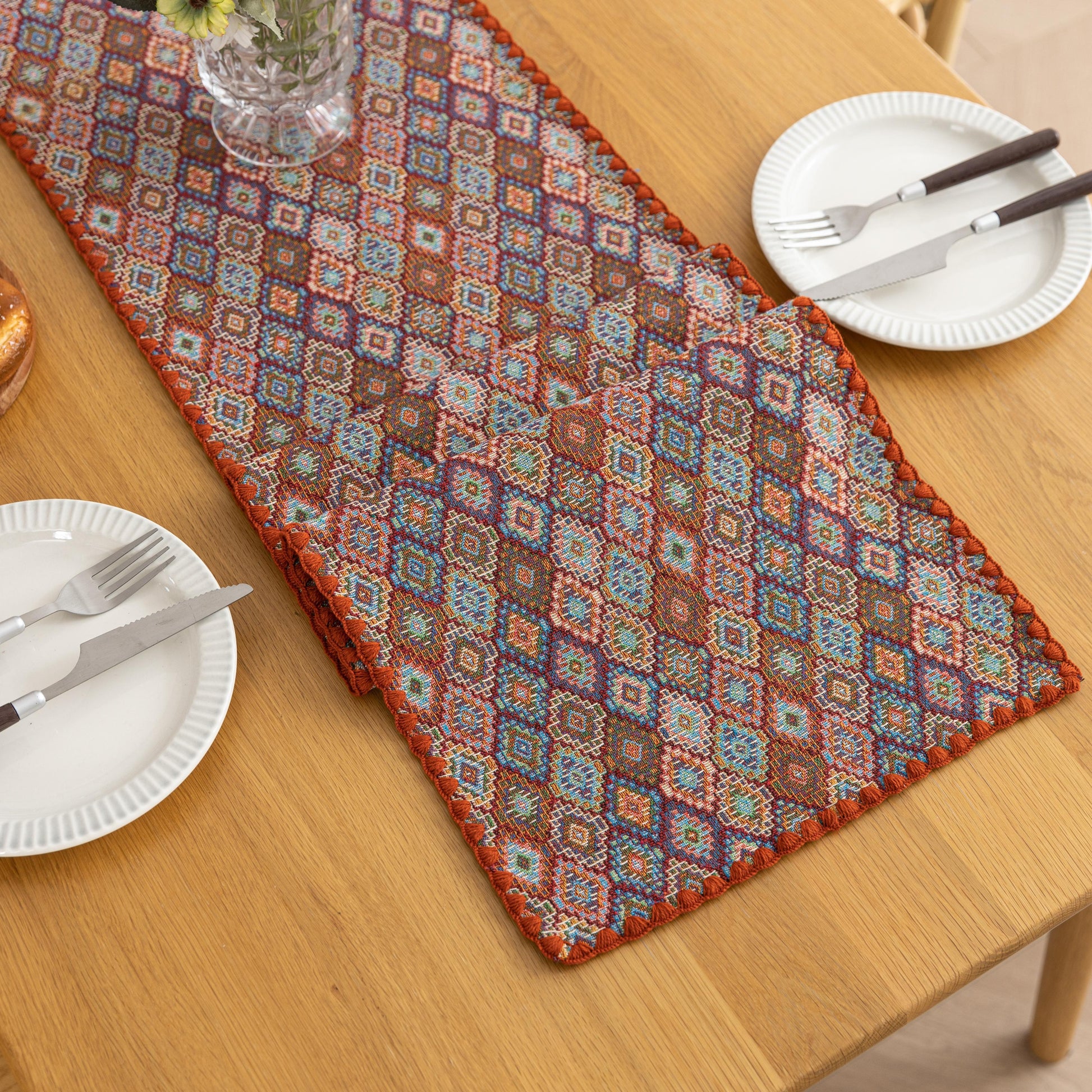 Colorful woven table runner with intricate diamond patterns, perfect for adding a vibrant boho touch to your dining or coffee table décor.
