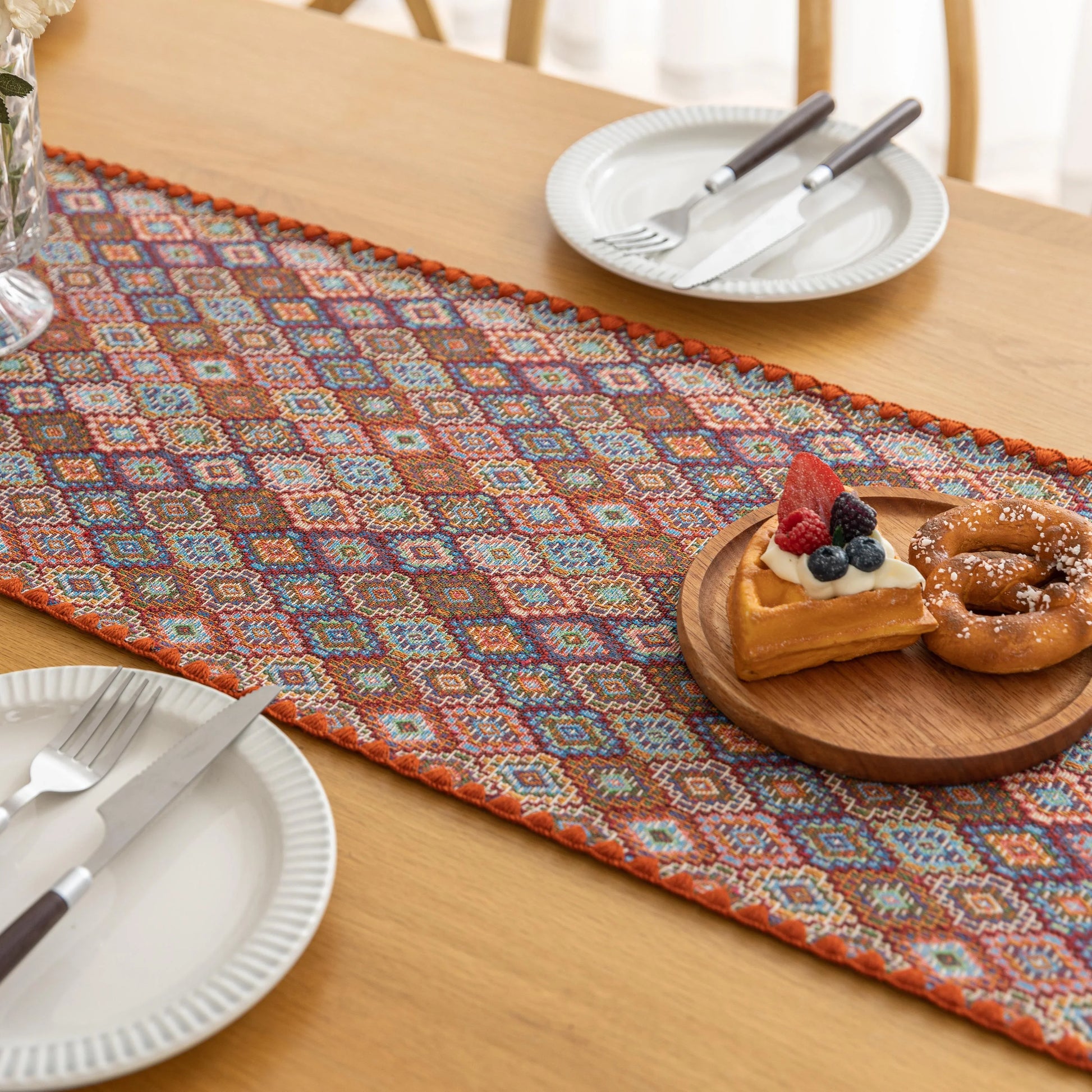 Colorful woven table runner with intricate diamond patterns, perfect for adding a vibrant boho touch to your dining or coffee table décor.